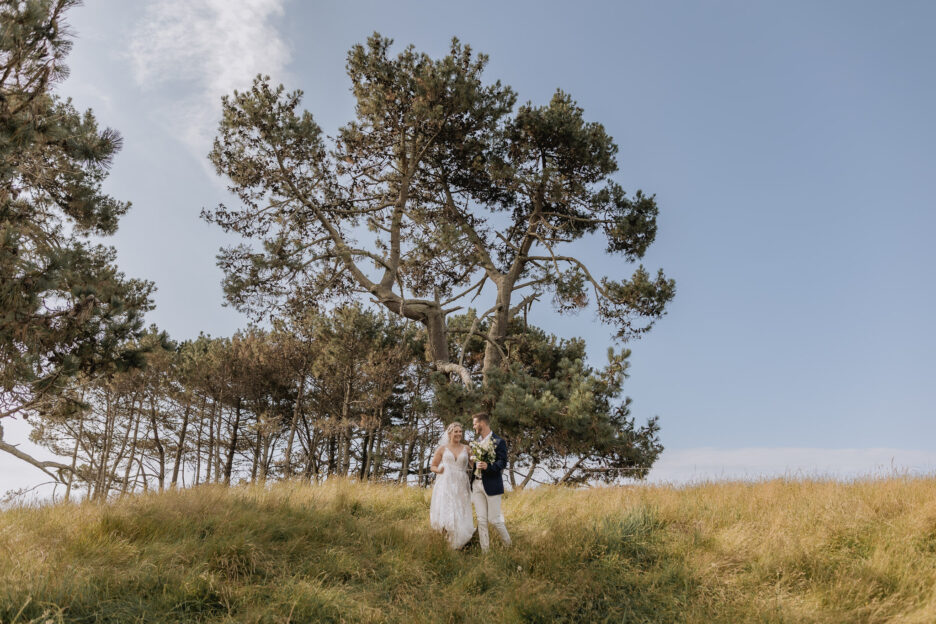 Bride and groom walking country side Te Tumu Papamoa