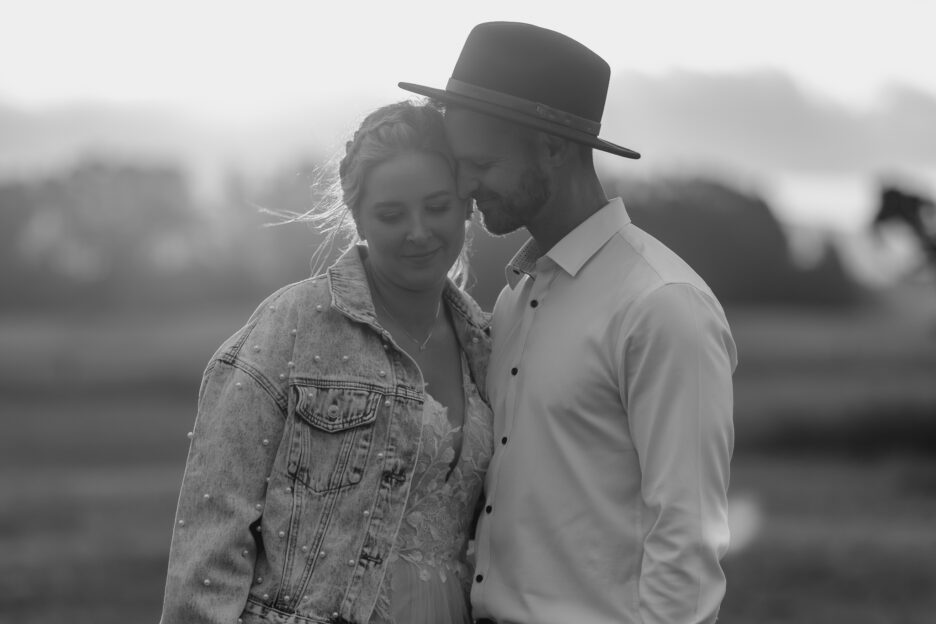 wedding couple cuddling while walking during photography session