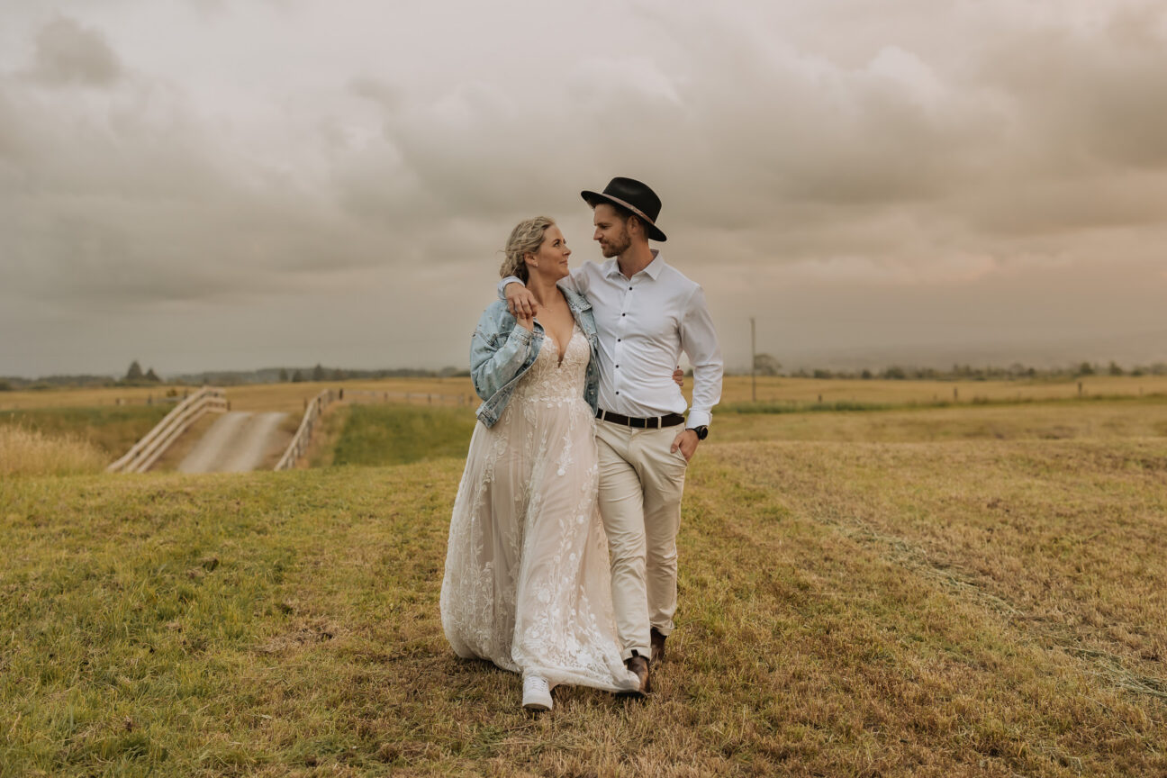 Bride and groom walking at dusk at Te Tumu estate