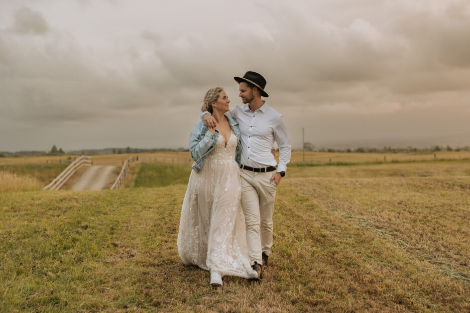 Bride and groom walking at dusk at Te Tumu estate