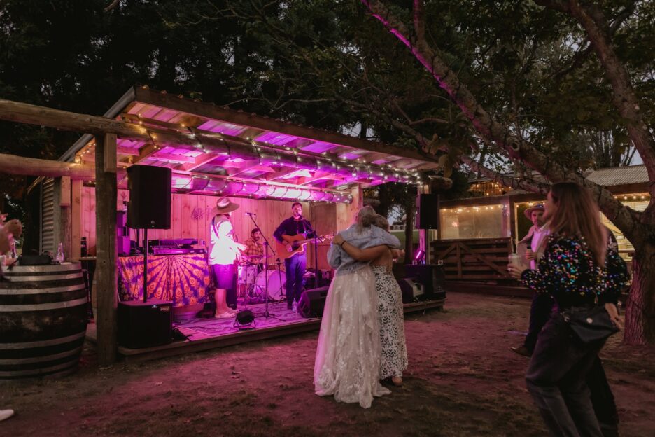 bride enjoying music with bridesmaid