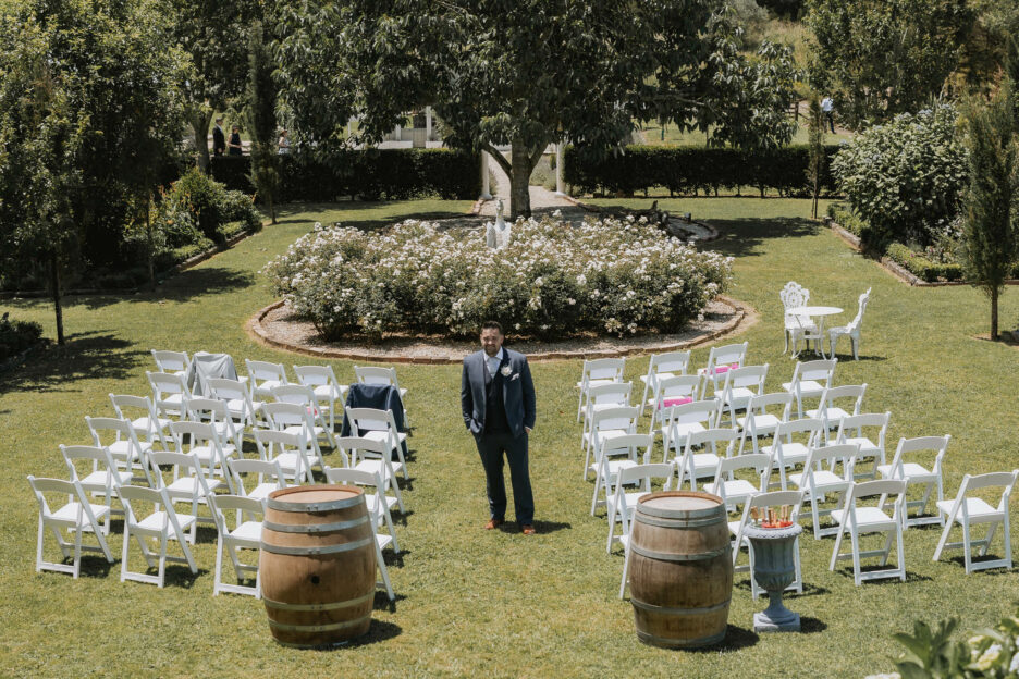 Groom standing in ceremony area Villa vie