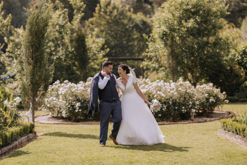 bride and groom walking laughing Villa Vie gardens