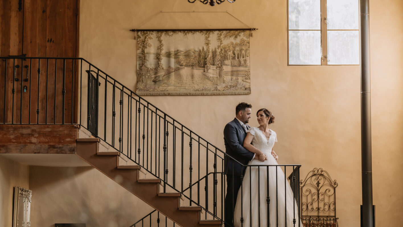 Bride looking at groom on Villa Vie country house staircase