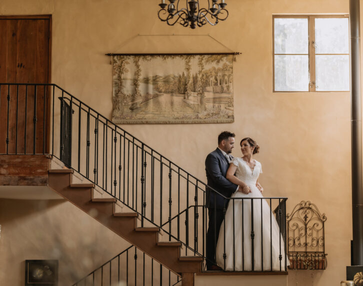 Bride looking at groom on Villa Vie country house staircase