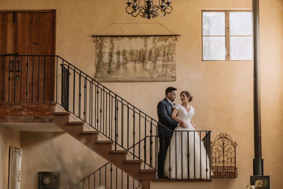 Bride looking at groom on Villa Vie country house staircase