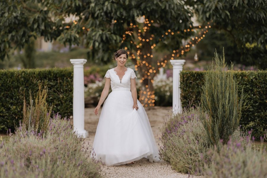 Bride in JJ's house wedding dress by fairy lights tree Villa Vie Estate