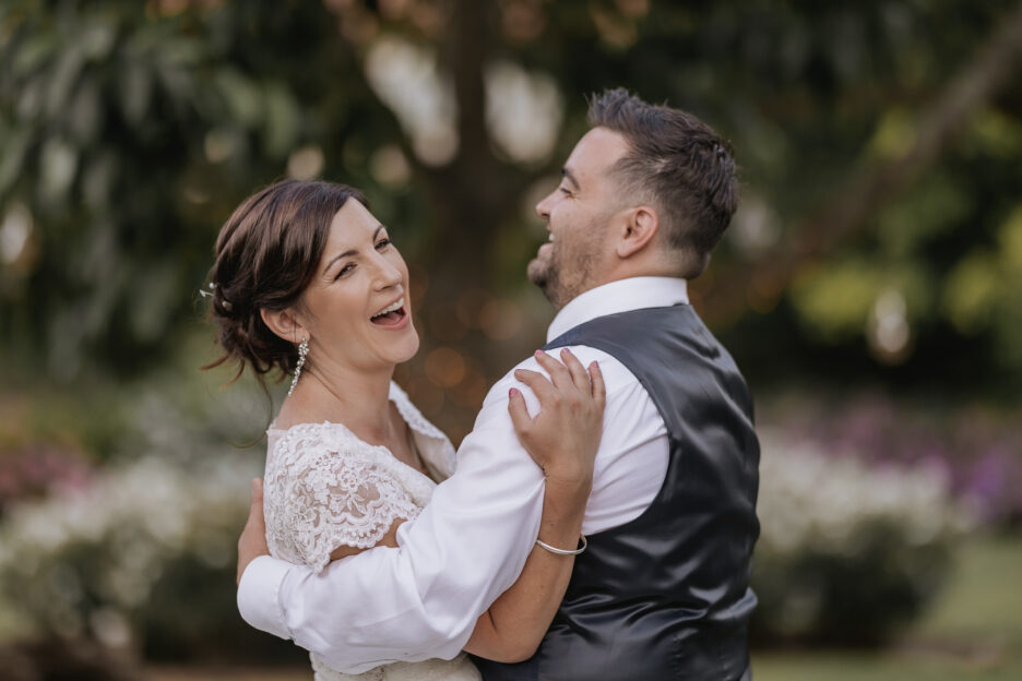 Candid laughing photo of wedding couple in the garden of Villa Vie