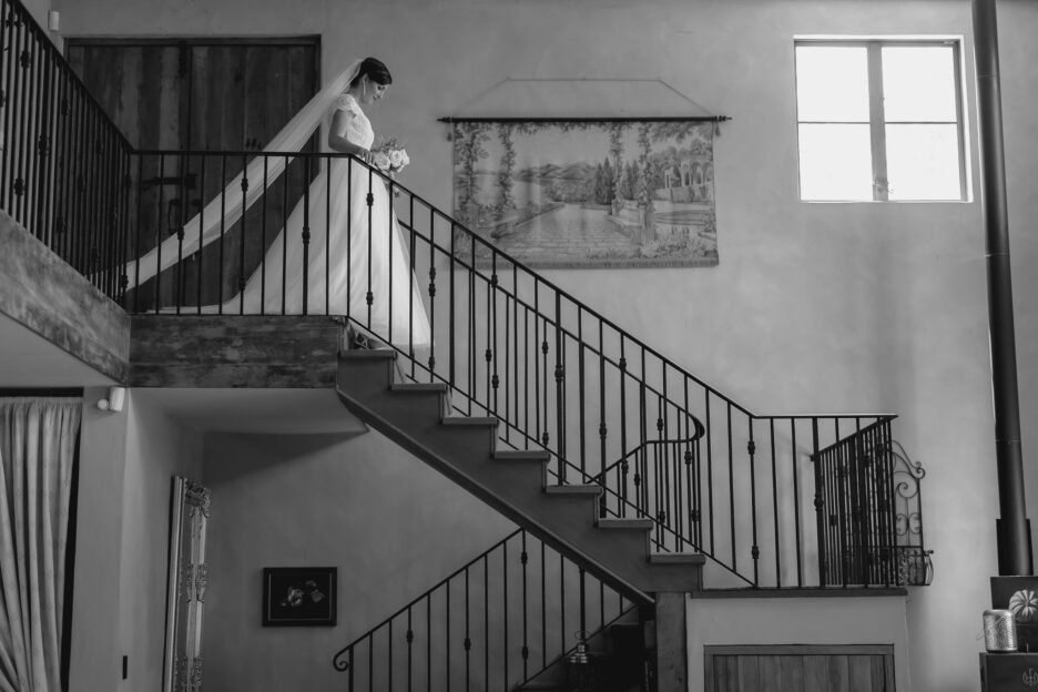 Bride on stairs at villa vie stair case