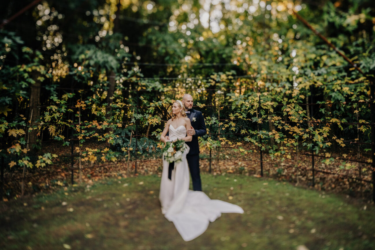 wedding couple hugging in tree church surrounded by greenery