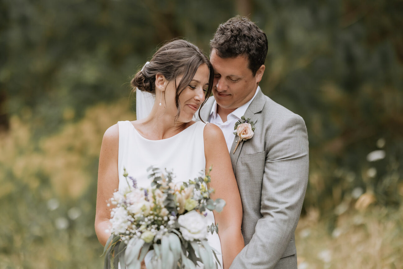 beautiful intimate moment between bride and groom in country lane