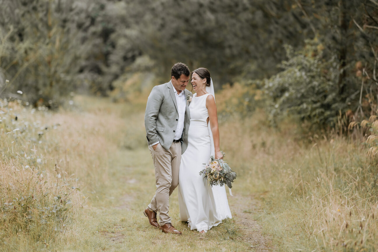 bride and groom walking laughing giggling having a funny moment