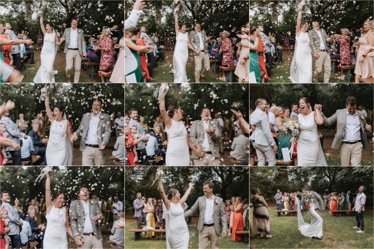 happy wedding couple walk down aisle with confetti being thrown