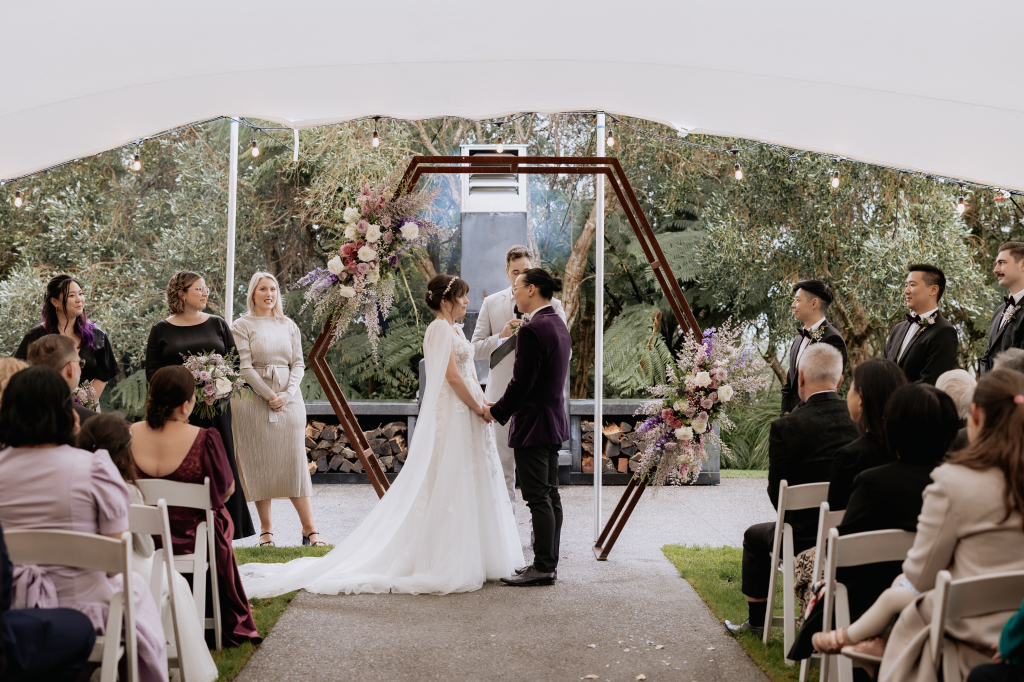 couple get married in front of outdoor fireplace Eagle ridge