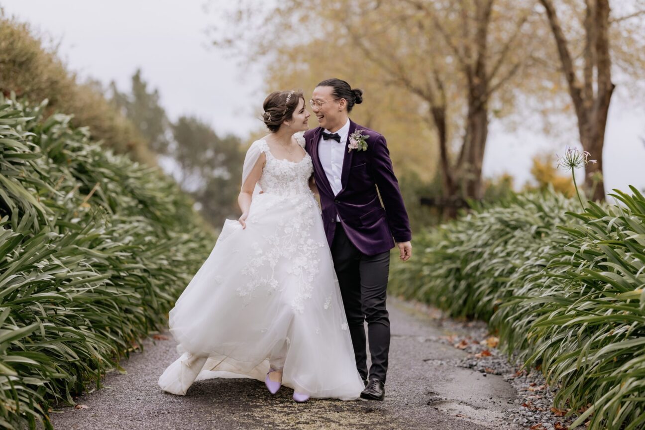 wedding couple walking happily on driveway eagle ridge