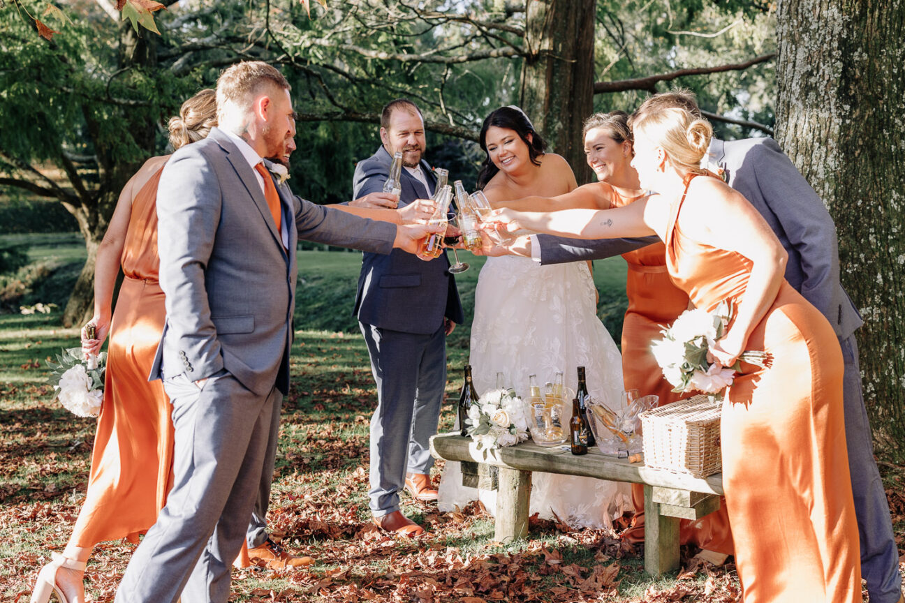 wedding party congratulates cheering glasses of champagne waterlily gardens