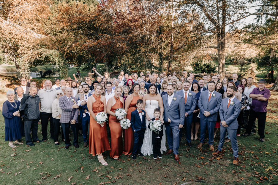 Group wedding guest photo on lawn waterlily gardens waihi