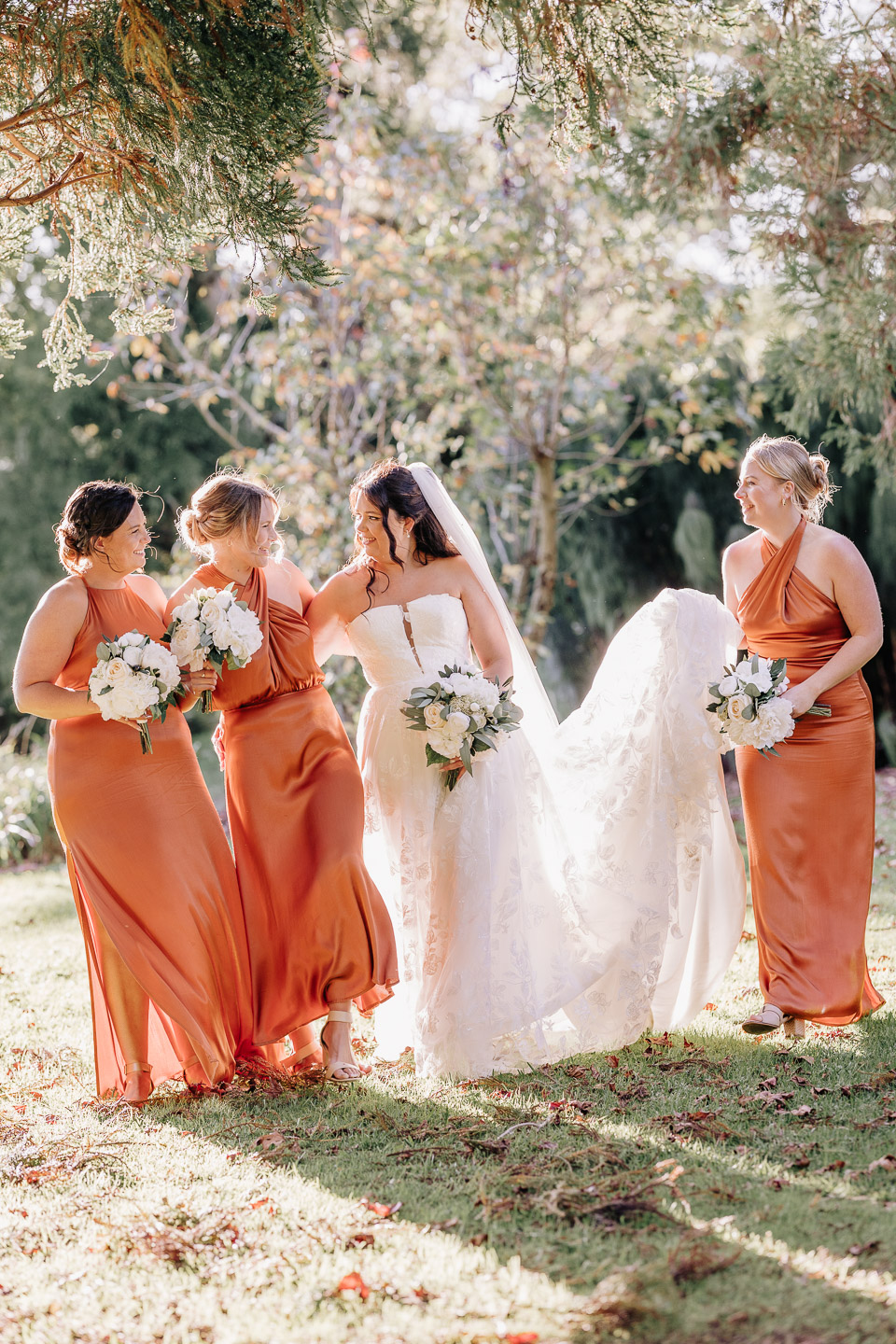 Autumn wedding party walking with bridesmaids at waterlily gardens.