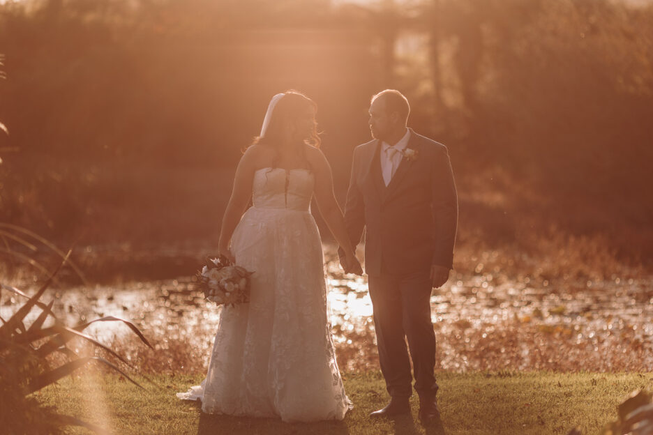 Wedding photos at Golden light across pond Waterlily gardens Pure Images Photography