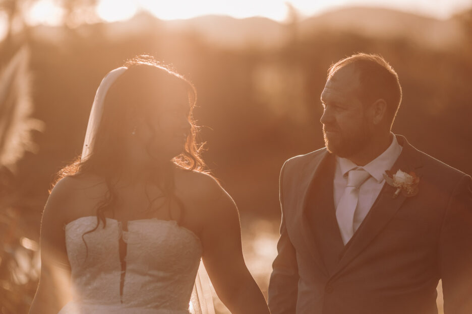 wedding couple walking in golden light waterlily gardens