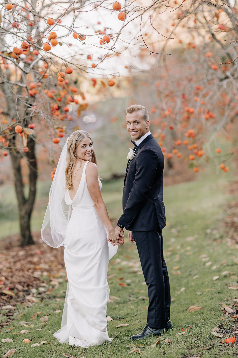 wedding photography of a bride and groom looking back to the wedding photographer