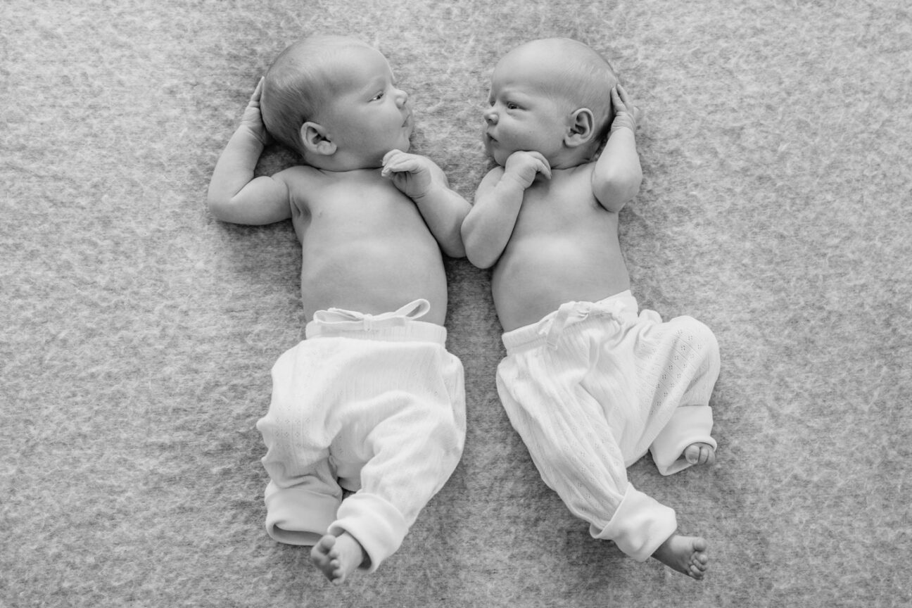 newborn twins looking at each other