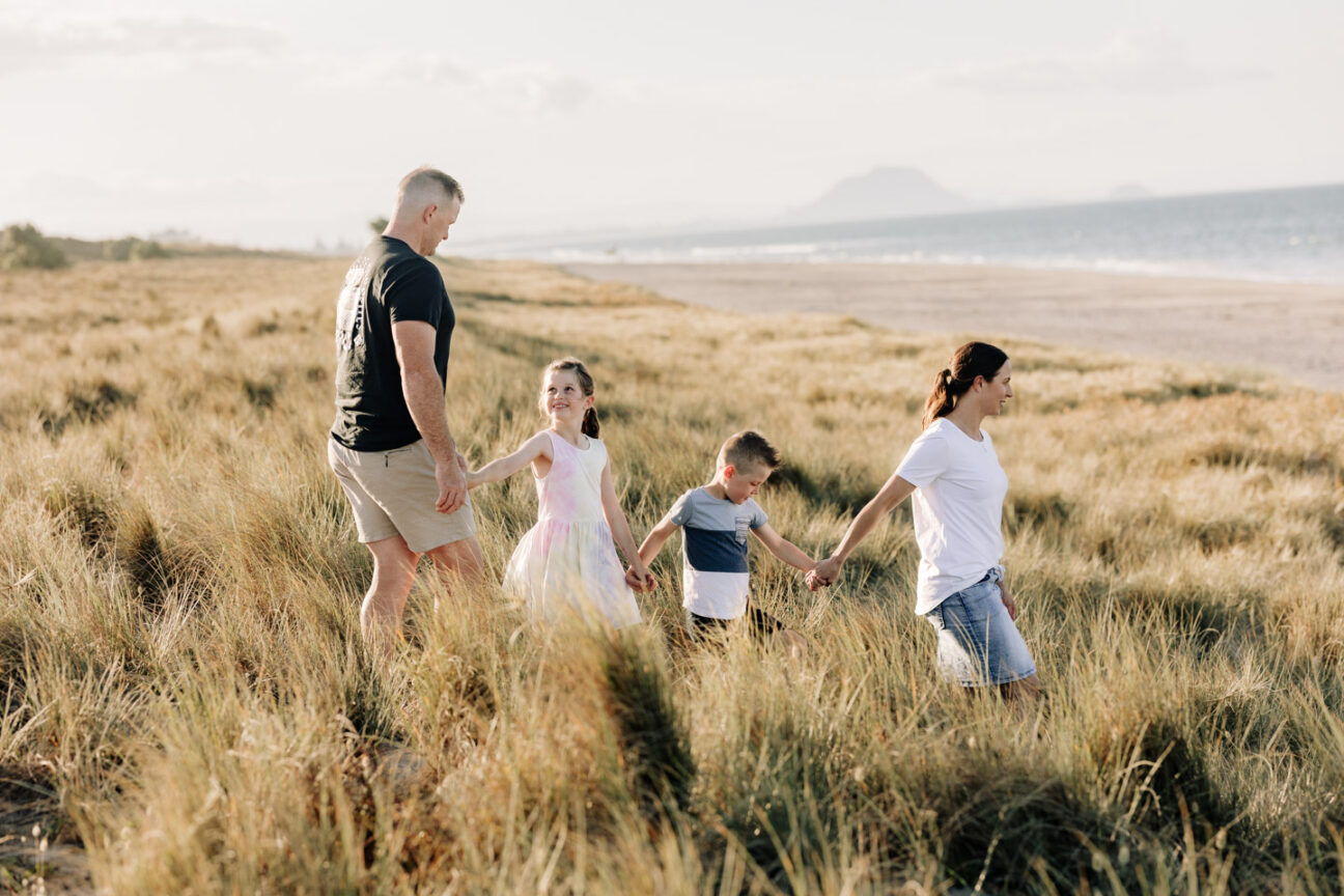 family walking through dunes papamoa beach