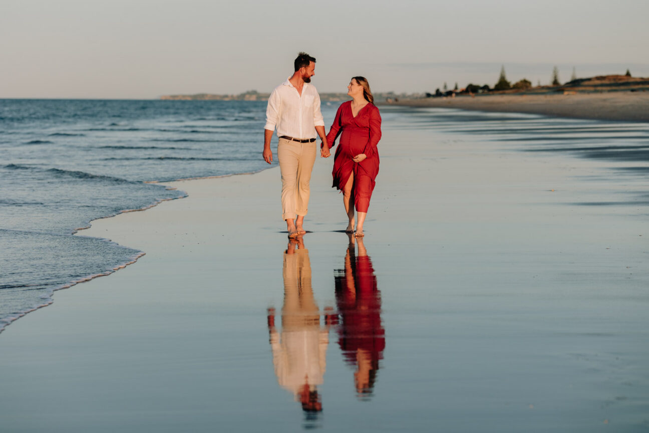 Maternity shoot with mum and Dad walking papamoa beach