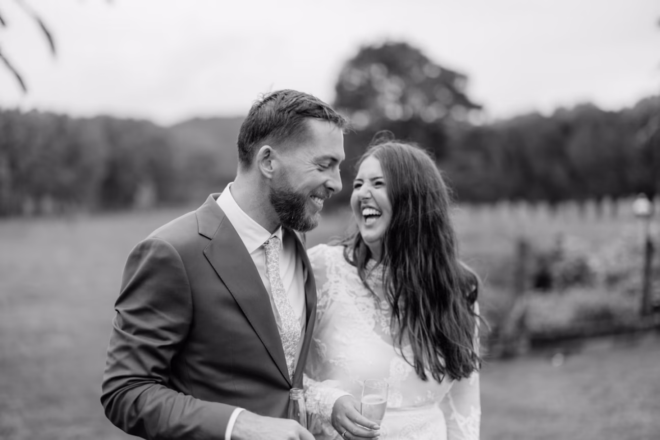 laughing bride and groom at whangamata farm weddings