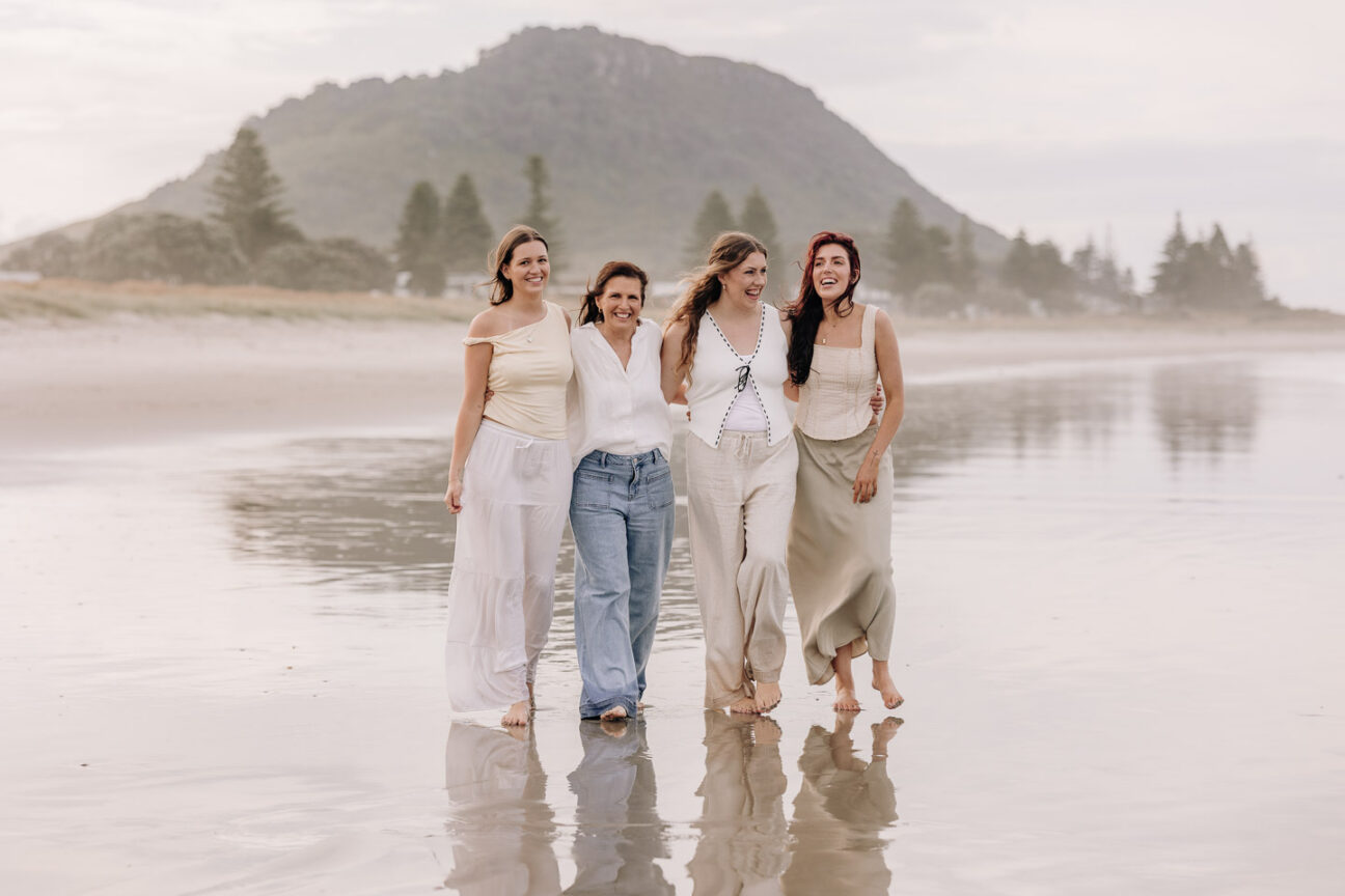 Mum with daughters walking on mount maunganui beach