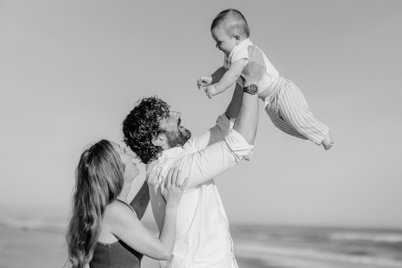 dad playing with baby holding baby up playing